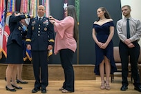Maj. Gen. Barbara Holcomb (left) and Jacquie Davis (right) place Brig. Gen. Jack Davis' new rank on his jacket as his daughter, Katie, and son, Jacob, look on, during a ceremony in METC’s Anderson Hall Auditorium at Joint Base San Antonio-Fort Sam Houston June 7. Davis is the current Commandant of the Medical Education and Training Campus at JBSA-FSH. He is the incoming Chief of the U.S. Army Nurse Corps; Deputy Commanding General Regional Health Command-Pacific; Deputy Command Surgeon, U.S. Army Pacific, and Senior Market Manager,  Hawaii Enhanced Multi-Serive Market. Honolulu, Hawaii.