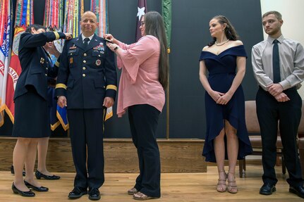 Maj. Gen. Barbara Holcomb (left) and Jacquie Davis (right) place Brig. Gen. Jack Davis' new rank on his jacket as his daughter, Katie, and son, Jacob, look on, during a ceremony in METC’s Anderson Hall Auditorium at Joint Base San Antonio-Fort Sam Houston June 7. Davis is the current Commandant of the Medical Education and Training Campus at JBSA-FSH. He is the incoming Chief of the U.S. Army Nurse Corps; Deputy Commanding General Regional Health Command-Pacific; Deputy Command Surgeon, U.S. Army Pacific, and Senior Market Manager,  Hawaii Enhanced Multi-Serive Market. Honolulu, Hawaii.