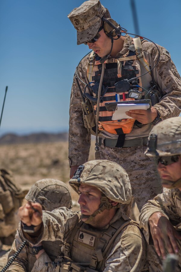 U.S. Marine forward observers attached from I Battery, 3rd Battalion, 14th Marine Regiment, 4th Marine Division, call for fire while an exercise controller with Tactical Training Exercise Control Group, Marine Air Ground Task Force Training Command, observes during the mechanized assault course during Integrated Training Exercise 4-19 at Marine Corps Air Ground Combat Center, Twentynine Palms, Calif., June 12, 2019. The ITX force includes each of the Marine Air-Ground Task Force’s subordinate elements who work together in the application of combined-arms maneuver warfare during the exercise. (U.S. Marine Corps photo by Lance Cpl. Preston L. Morris)