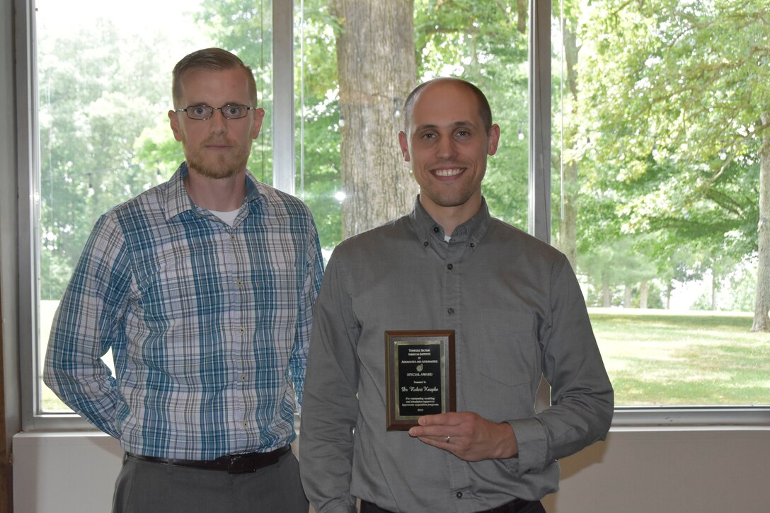 Dr. Robert Knapke, right, receives an AIAA Special Award for outstanding modeling and simulation support to hypersonic acquisition programs during the AIAA Annual Awards Luncheon May 30 at the Arnold Lakeside Center. Also pictured is Craig Morris, who nominated Knapke for the award. (U.S. Air Force photo by Bradley Hicks)