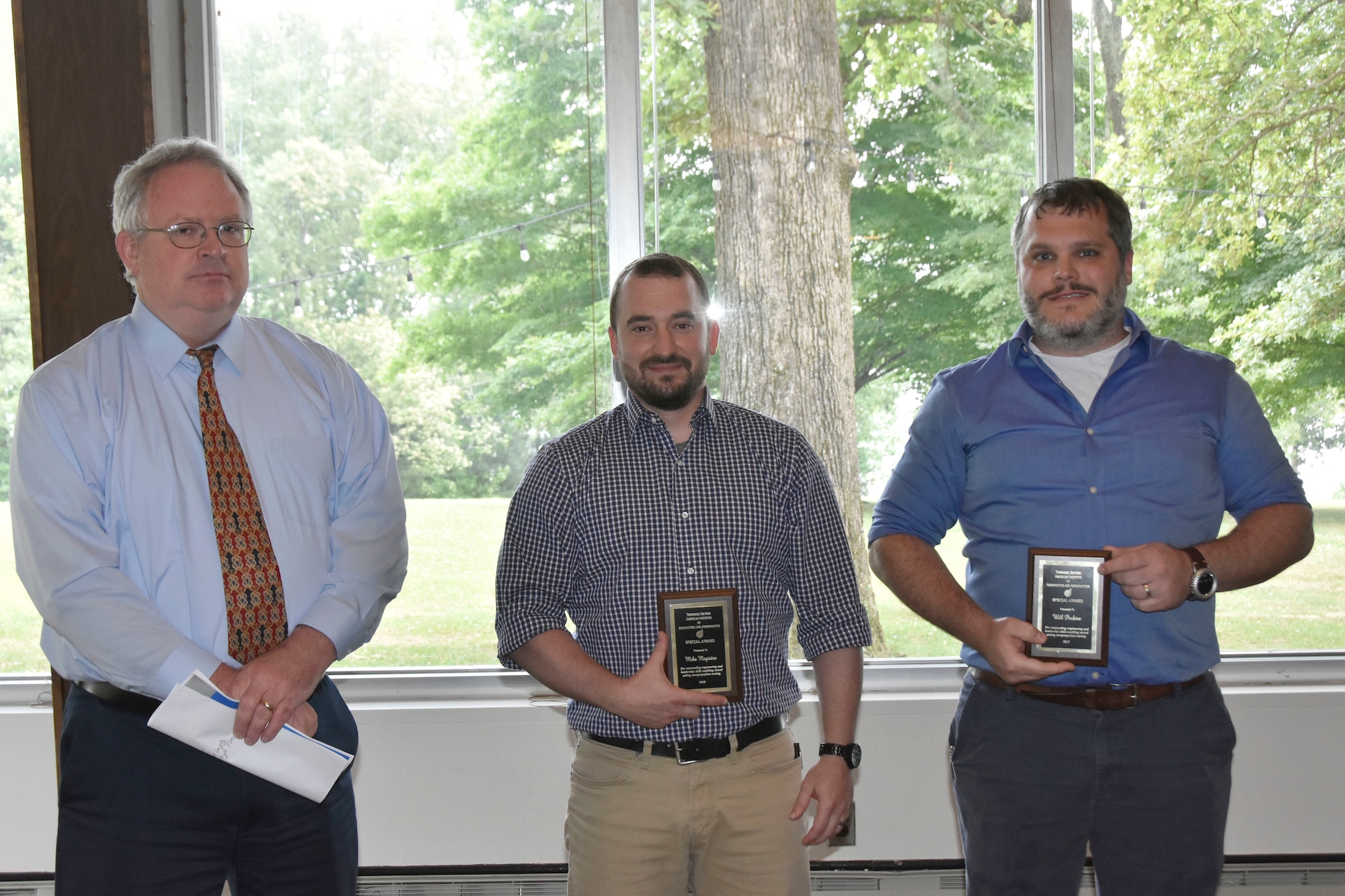 Mike Magistro, center, and Will Perkins, right, accept an AIAA Special Award during the AIAA Annual Awards Luncheon May 30 at the Arnold Lakeside Center. Magistro and Perkins received the awards for outstanding engineering and leadership skills that enabled record-setting aeropropulsion testing in the Aeropropulsion Systems Test Facility. Also pictured is Steve Arnold, who nominated Magistro and Perkins for the award. (U.S. Air Force photo by Bradley Hicks)