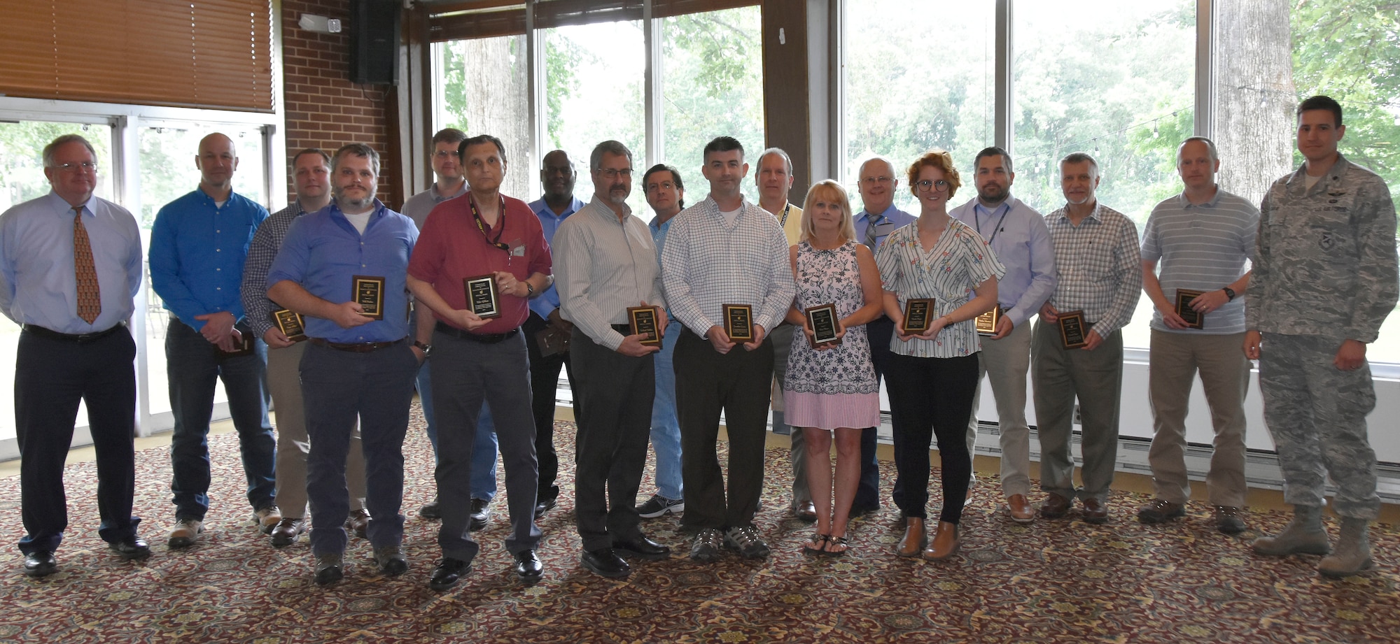 Members of the Adaptive Engine Technology Demonstrator Test Team accept an AIAA Special Award for their work on the AETD Core Engine Test during the AIAA Annual Awards May 30 at the Arnold Lakeside Center. Pictured at far left is Steve Arnold, who nominated the team for the award. (U.S. Air Force photo by Bradley Hicks) (This image was altered by obscuring badges for security purposes)