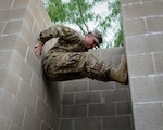 An Air Force recruiter with the 330th Recruiting Squadron practices climbing a wall following instruction from survival, evasion, resistance and escape cadre members from 66th Training Squadron, Det. 3, at Joint Base San Antonio-Lackland June 3. Survival, Evasion, Resistance and Escape cadre are responsible for both the four-day Evasion and Conduct After Capture Course and the 15-day SERE Specialist Training Orientation Course at JBSA-Lackland. ECAC was the first stop for recruiters from the 330th RCS who travelled from across the United States to attend this biannual squadron training intended to immerse recruiters into SERE training in order for them to be better able to recruit Air Force SERE candidates.