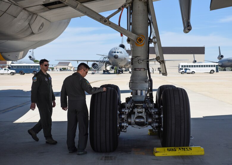 Capt. Joseph Alessi, 78th Air Refueling Squadron aircraft commander, passes knowledge to 1st. Lt Alexandro Retamozo as they walk under a KC-10 Extender, May 21, 2019. Pilots are always learning from one another. (Photo by U.S. Air Force 1st Lt. Katie Mueller)