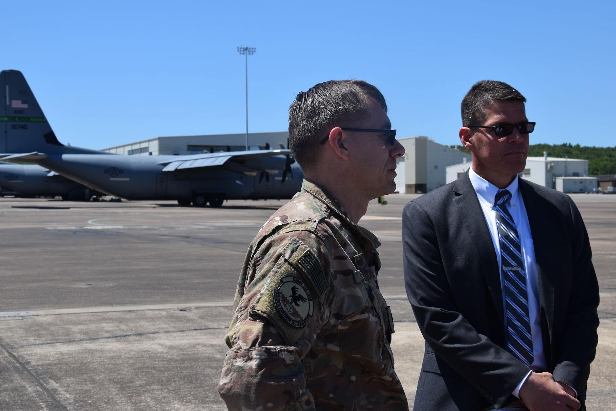 Two Airmen talk on the flight line