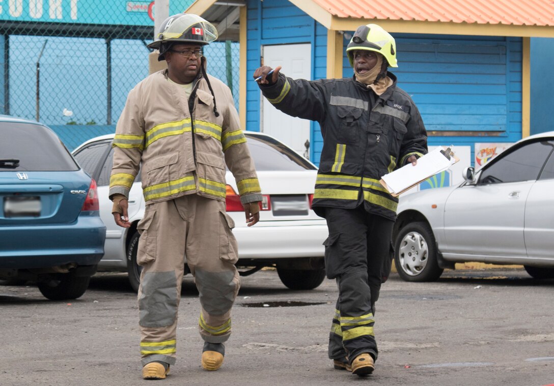 Members of the Saint Vincent and the Grenadines fire department put out a simulated fire upon arrival during phase II of Tradewinds 2019.