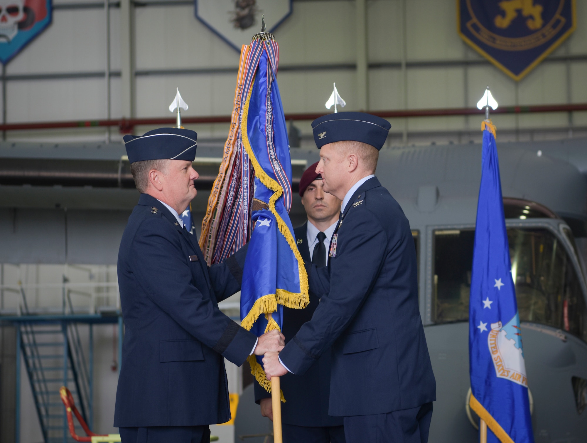 Two people holding a flag.