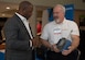 A company representative speaks to an event attendee about a product during the Tactical and Tech Day Expo at Joint Base Langley-Eustis, Virginia, June 12, 2019.