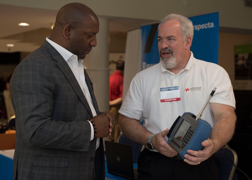 A company representative speaks to an event attendee about a product during the Tactical and Tech Day Expo at Joint Base Langley-Eustis, Virginia, June 12, 2019.