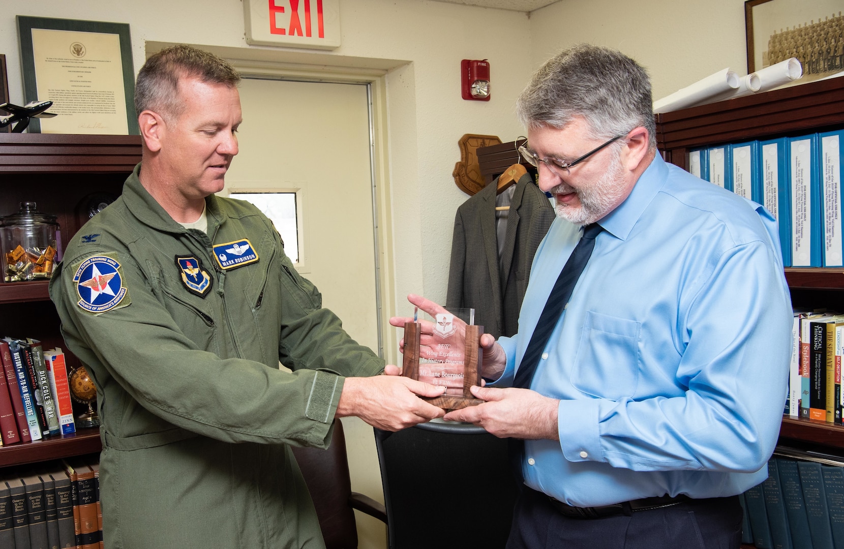 Col. Mark Robinson (left), 12th Flying Training Wing commander, presented Lane Bourgeois (right), 12th FTW historian, with the 2019 Wing Excellence in History Programs award from Air Education and Training Command at Joint Base San Antonio-Randolph June 12. Lane was recognized for his critical thinking presentations and for being the first wing to produce a historical study in the new format.