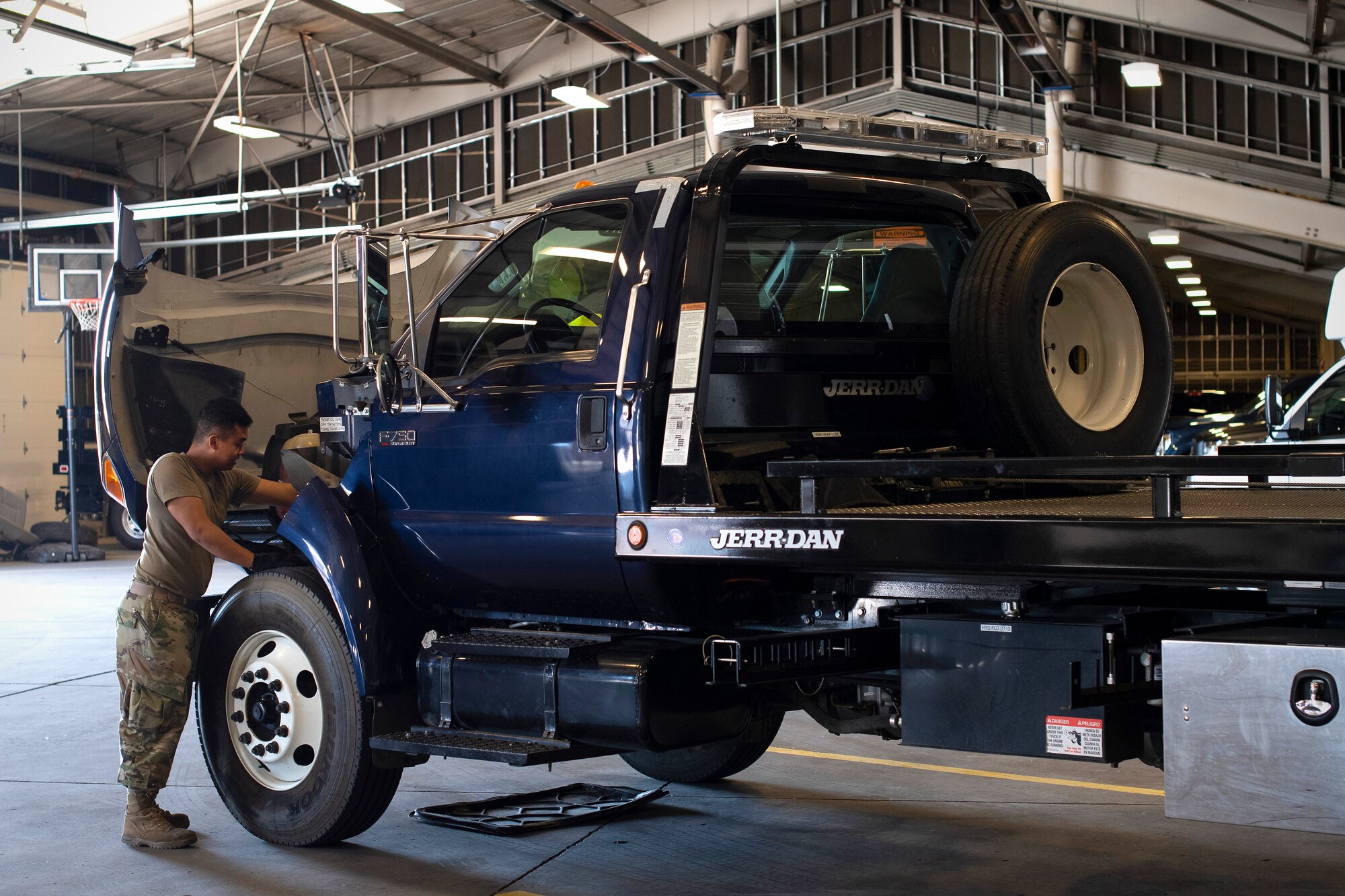 Airman 1st Class Brandon Nunsure, 319th logistics Readiness Squadron vehicle operations apprentice, checks beneath the hood of a towing services truck June 12, 2019, on Grand Forks Air Force Base, North Dakota. The 319 LRS is responsible for 266 vehicles on on Grand Forks AFB, to include those used for commercial heavyduty, aircraft towing and servicing, construction and base maintenance, refueling, firefighting, snow removal and more. (U.S. Air Force photo by Senior Airman Elora J. Martinez)