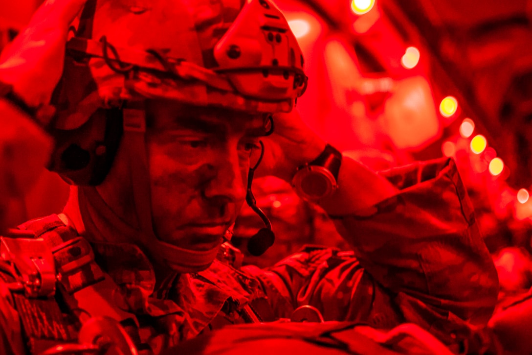 A soldier cast in red light.
