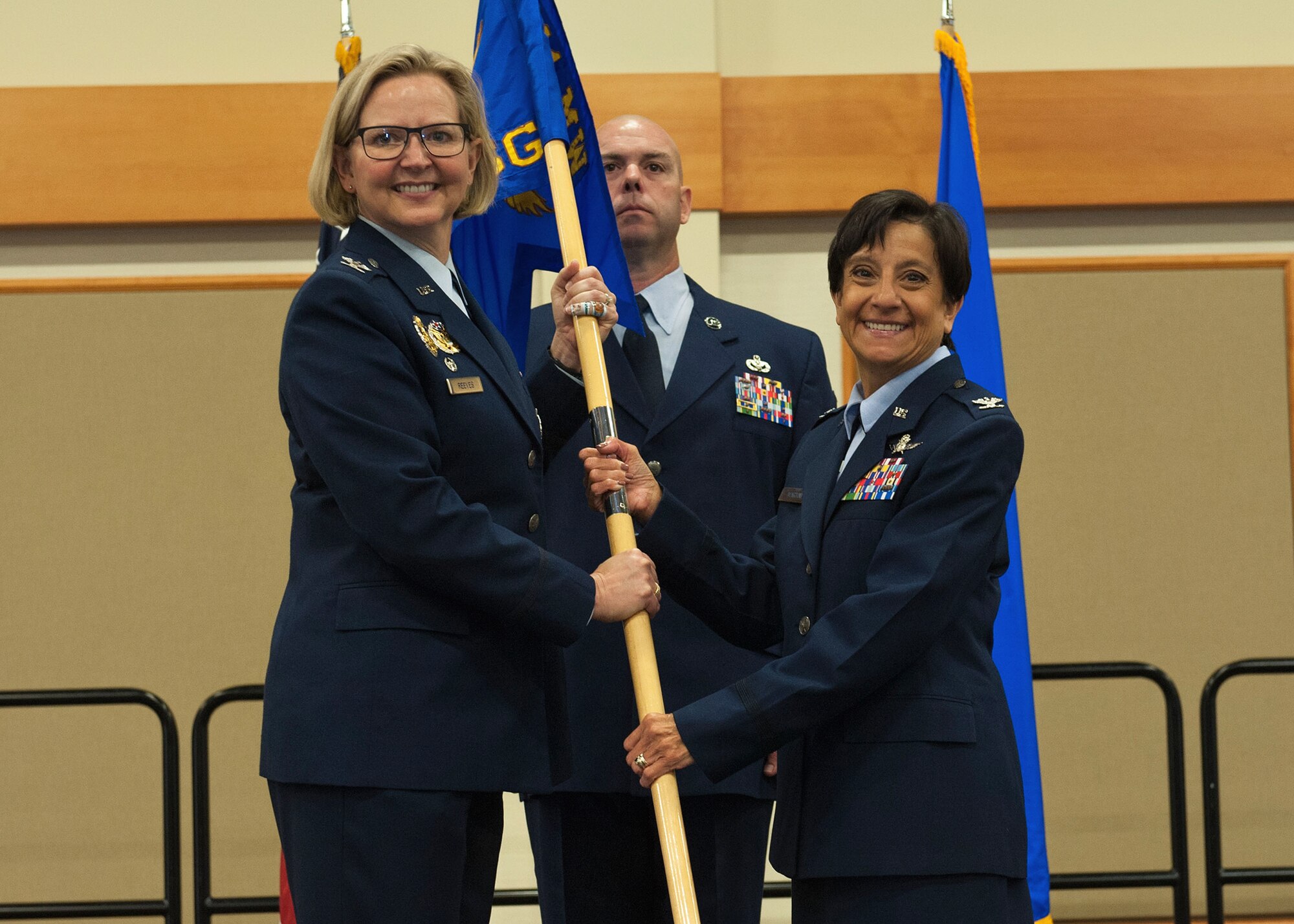 Col. Lisa Martinez, right, accepts command of the 341st Mission Support Group from Col. Jennifer Reeves, 341st Missile Wing commander during an assumption of command ceremony June 17, 2019, at Malmstrom Air Force Base, Mont. Guidon bearer Chief Master Sgt. Lance Blocher, 341st MSG group superintendent, looks on. (U.S. Air Force photo by John Turner)