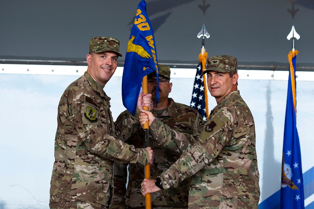 Col. John Chastain, right, 23d Maintenance Group (MXG) commander, relinquishes the 23d MXG guidon to Col. Daniel P. Walls, 23d Wing commander, during a change of command ceremony, June 17, 2019, at Moody Air Force Base, Ga. After being the commander for multiple squadrons within the Air Force maintenance community through various major commands, Chastain will be retiring today after more than 26 years of service to the nation and the Air Force. (U.S. Air Force photo by Senior Airman Erick Requadt)