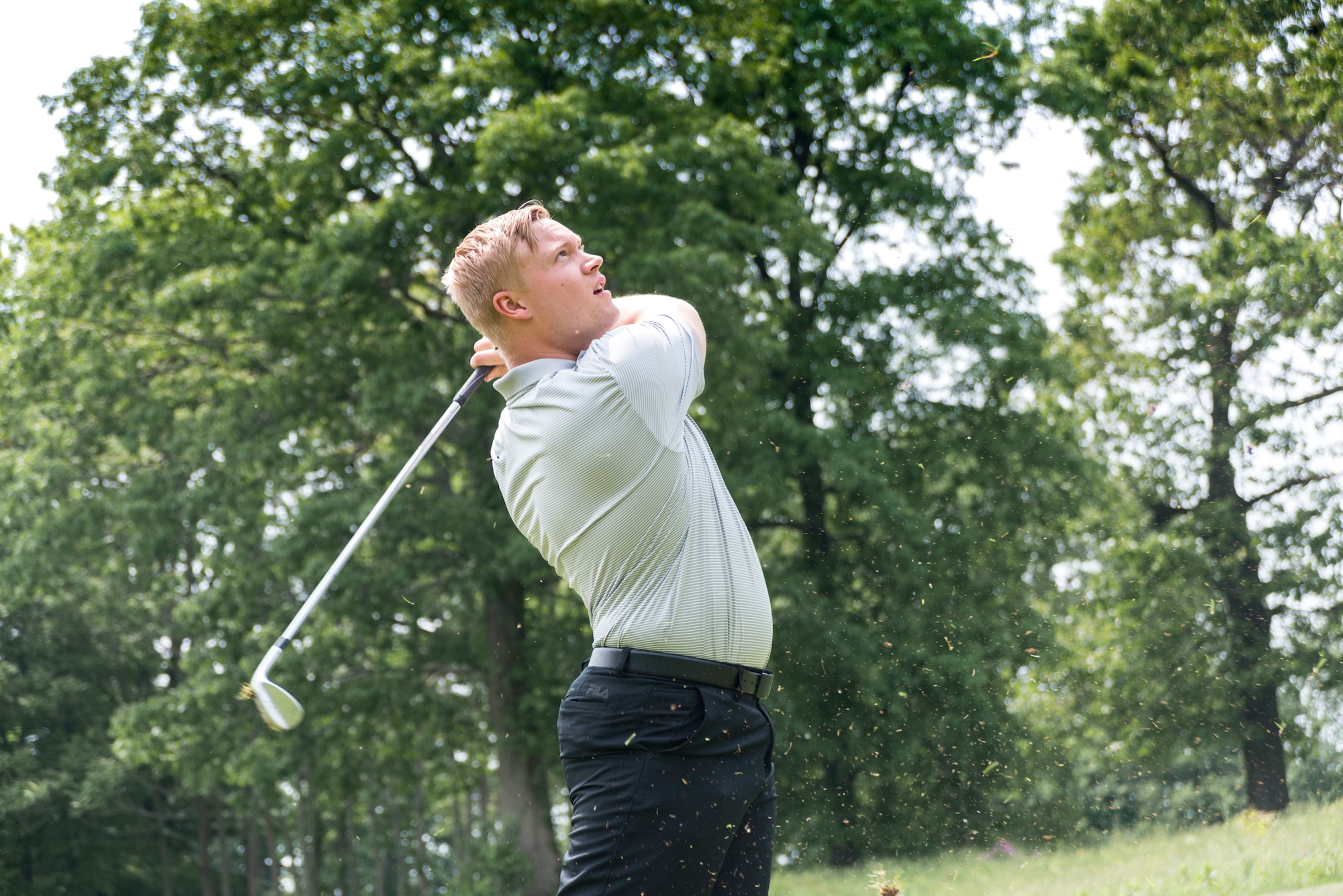 Staff Sgt. Justin Wielock, of the 103rd Civil Engineer Squadron, East Granby, Connecticut, swings his golf club June 1, 2019 at the Bogies for the Brave’s golf tournament at the Hunter Golf Club in Meriden, CT. Wielock sliced the grass with his swing and pushed the gold ball through the air and onto the green. The tournament was hosted by the non-profit organization Bogies for the Brave. (U.S. Air National Guard photo by Airman 1st Class Chanhda Ly)
