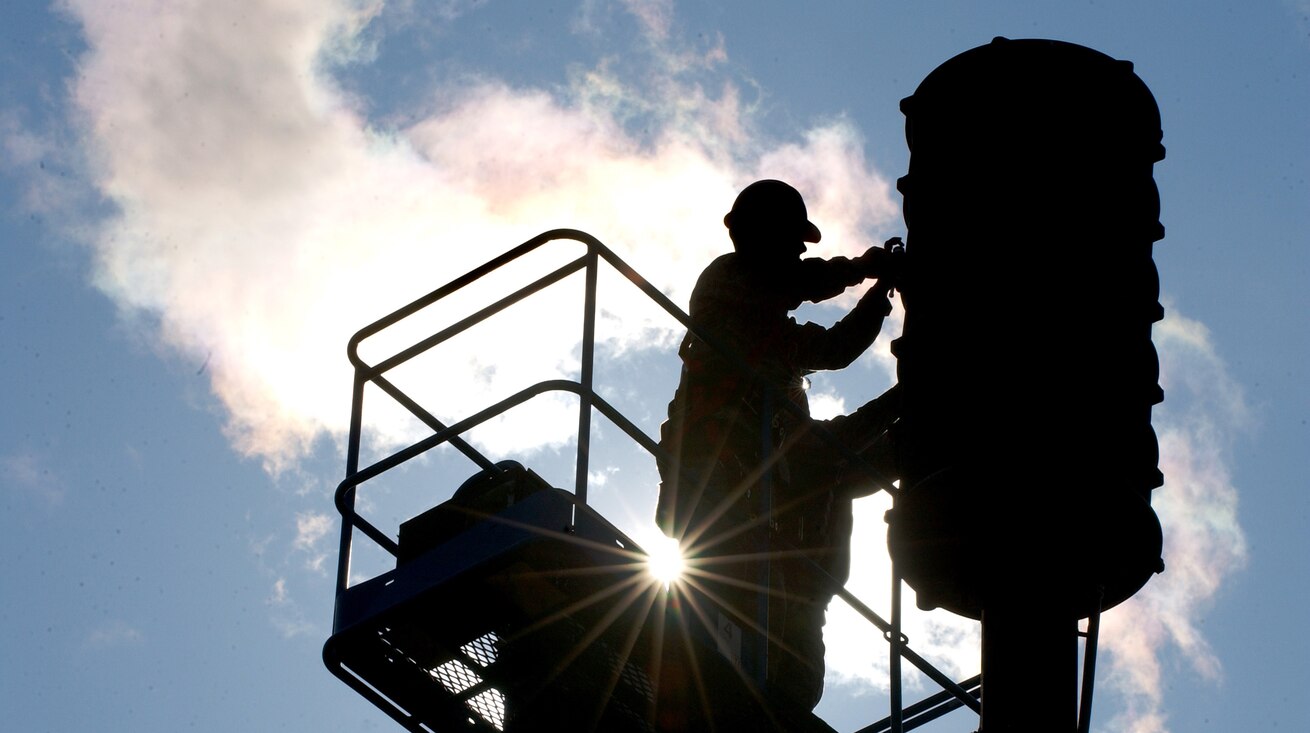 Airman finishes replacing a blown speaker in a giant voice system 