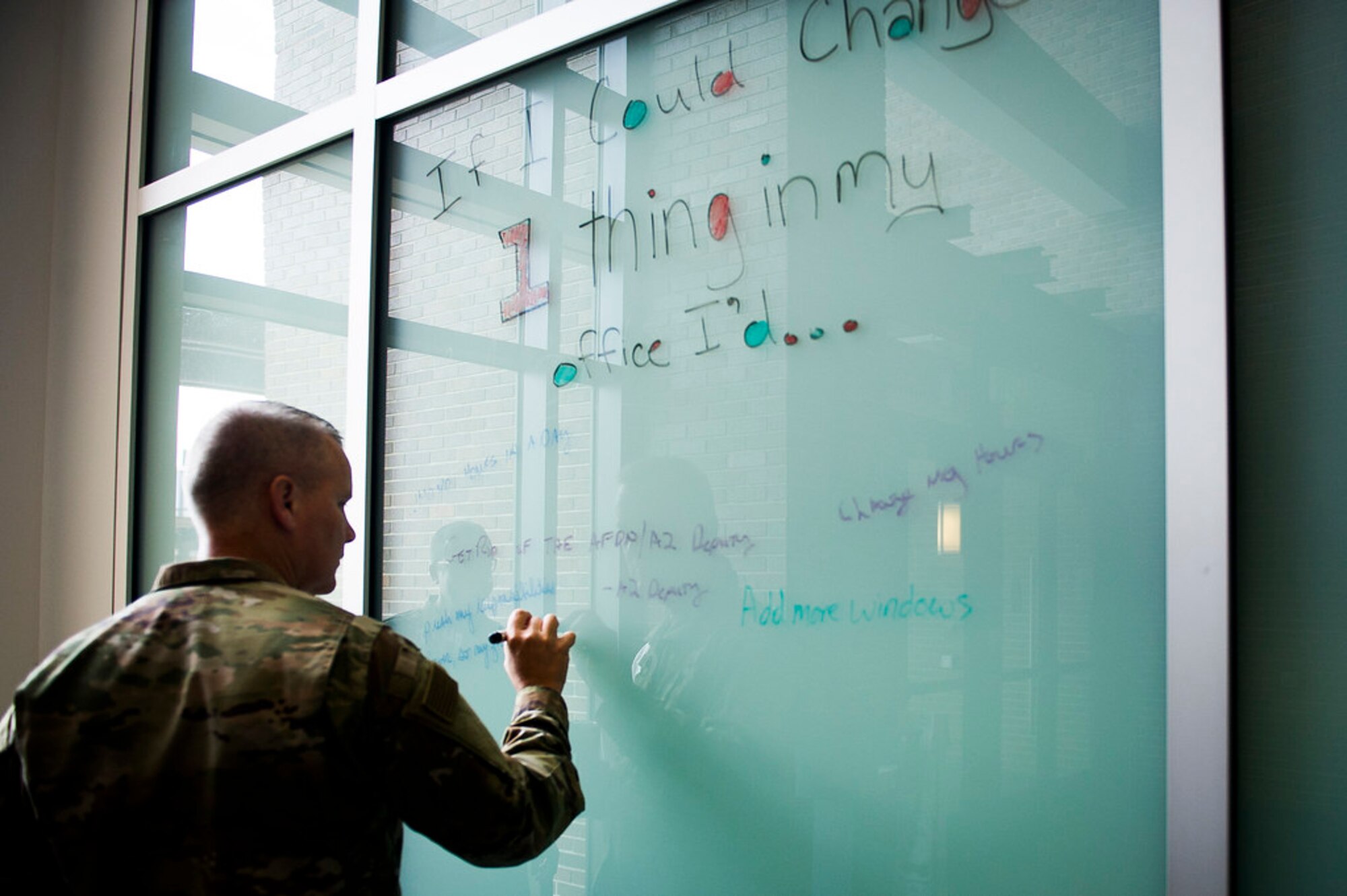 Maj. Gen. James A. Jacobson, Air Force District of Washington commander, writes a suggestion  in the Jones Building lobby during the first AFDW Innovation Summit at Joint Base Andrews, Md., June 12, 2019. (U.S. Air Force photo by Master Sgt. Michael B. Keller)