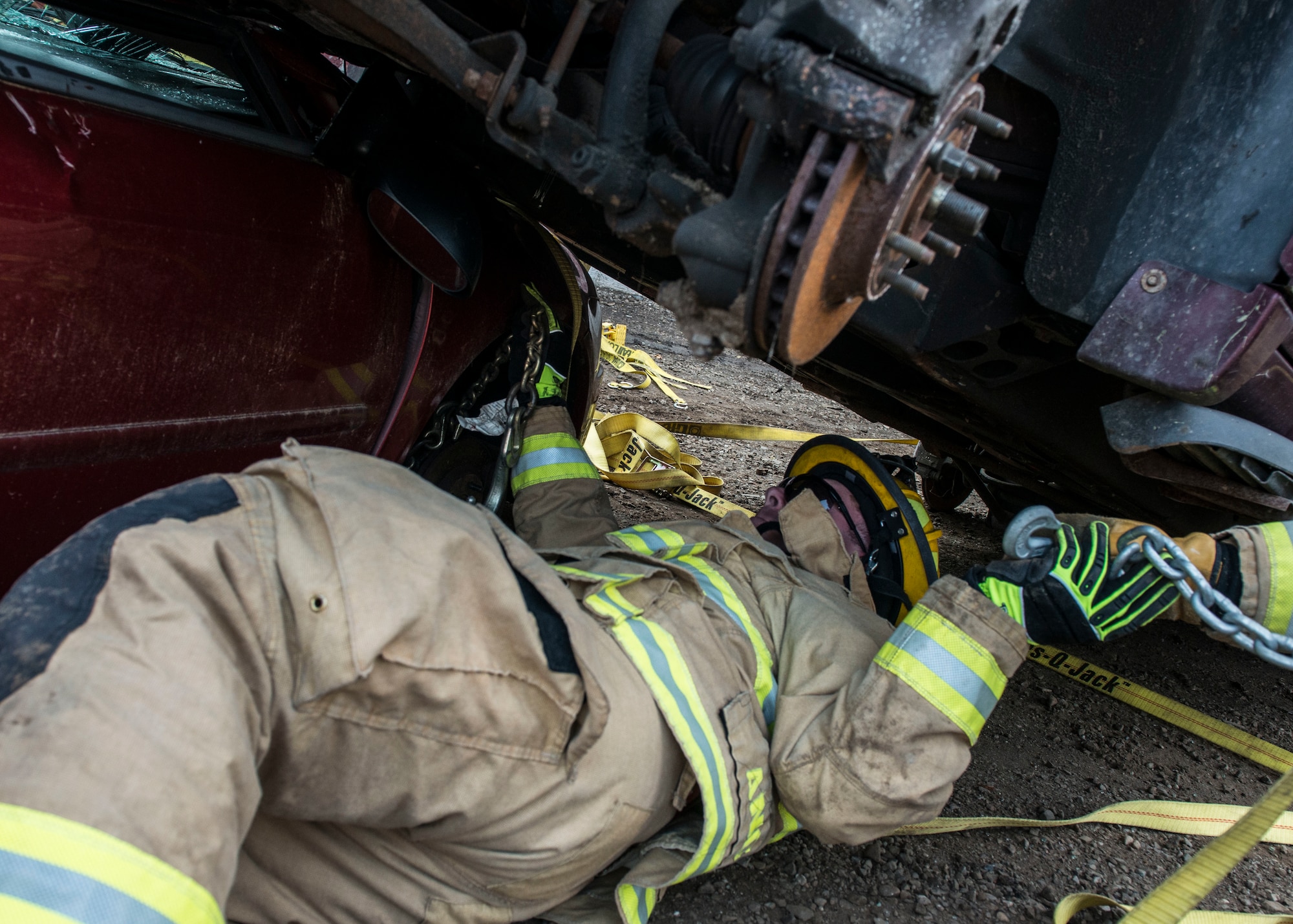 A firefighter assigned to the 103rd Civil Engineer Squadron, Connecticut Air National Guard attempts to remove a vehicle off of another vehicle as part of an auto accident scenario during a rescue strike team exercise, June 1, 2019 in East Granby, Conn. The firefighters trained with members of several local fire departments to ensure continuity in training across departments. (U.S. Air National Guard photo by Tech. Sgt. Tamara R. Dabney)