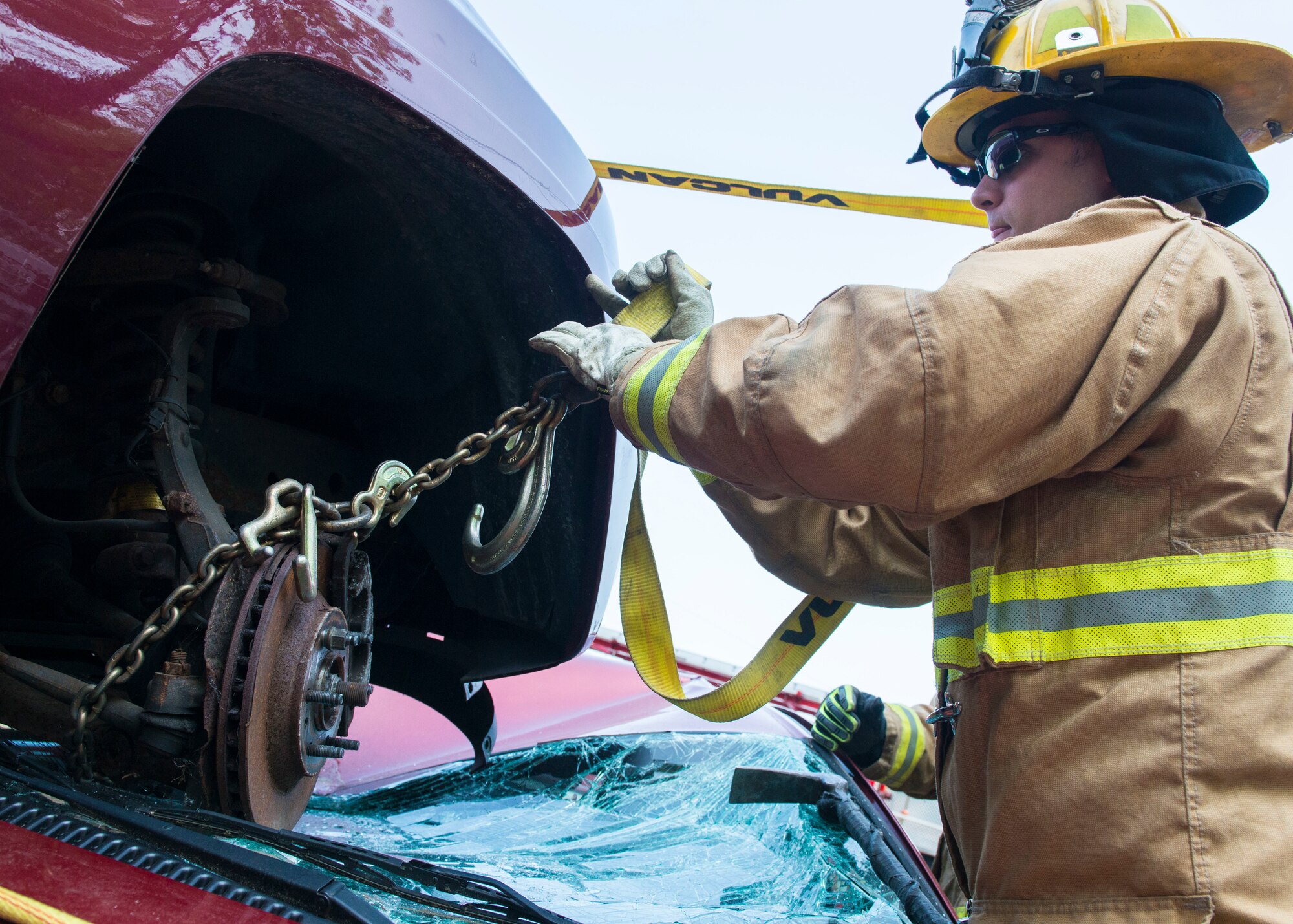 A firefighter assigned to the 103rd Civil Engineer Squadron, Connecticut Air National Guard attempts to remove a vehicle off of another vehicle as part of an auto accident scenario during a rescue strike team exercise, June 1, 2019 in East Granby, Conn. The firefighters trained with members of several local fire departments to ensure continuity in training across departments. (U.S. Air National Guard photo by Tech. Sgt. Tamara R. Dabney)