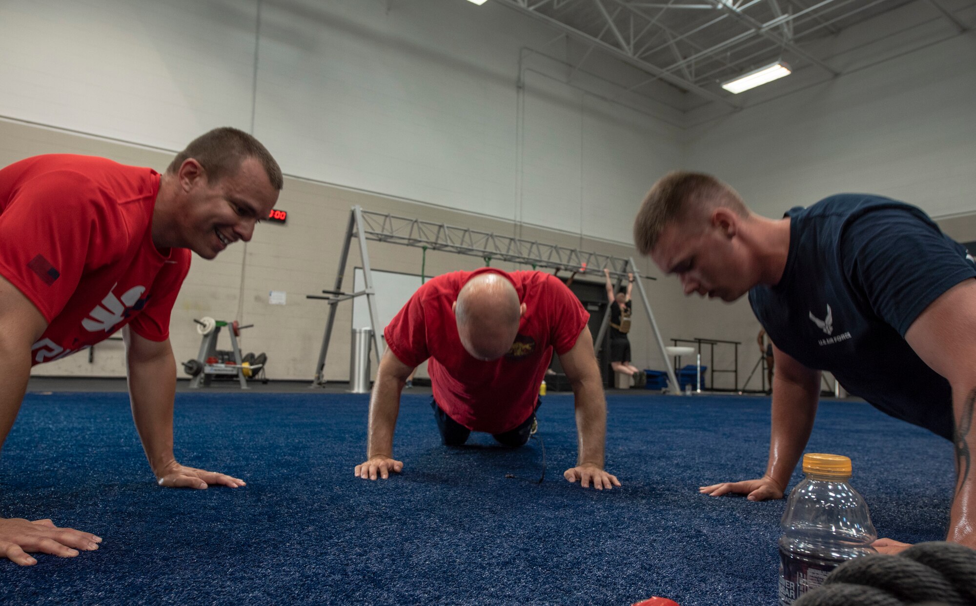 U.S. Airmen work together to complete a set of pushups during a “Murph challenge” at Shaw Air Force Base, May 28, South Carolina, 2019.
