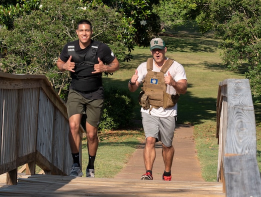 U.S. U.S. Staff Sgt. Carlos Wooten, 20th Fighter Wing (FW) religious affairs Airman, left, and Maj. Nicholas Lopresto, 20th Fighter Wing chaplain, participate in a “Murph challenge” complete their second 1-mile run at Memorial Lake, Shaw Air Force Base, South Carolina, May 28, 2019.