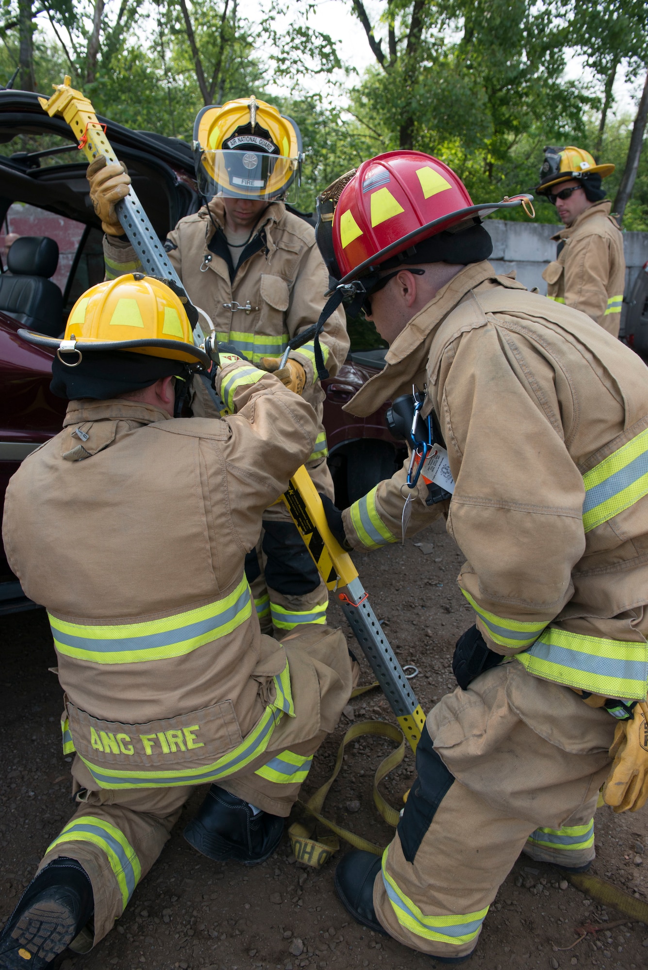 Firefighters assigned to the 103rd Civil Engineer Squadron, Connecticut Air National Guard attempt to remove a vehicle off of another vehicle as part of an auto accident scenario during a rescue strike team exercise, June 1, 2019 in East Granby, Conn. The firefighters trained with members of several local fire departments to ensure continuity in training across departments. (U.S. Air National Guard photo by Tech. Sgt. Tamara R. Dabney)