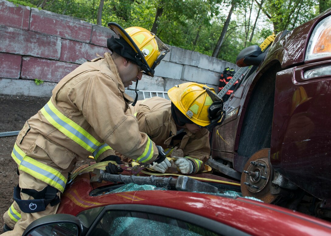 Firefighters assigned to the 103rd Civil Engineer Squadron, Connecticut Air National Guard attempt to remove a vehicle off of another vehicle as part of an auto accident scenario during a rescue strike team exercise, June 1, 2019 in East Granby, Conn. The firefighters trained with members of several local fire departments to ensure continuity in training across departments. (U.S. Air National Guard photo by Tech. Sgt. Tamara R. Dabney)