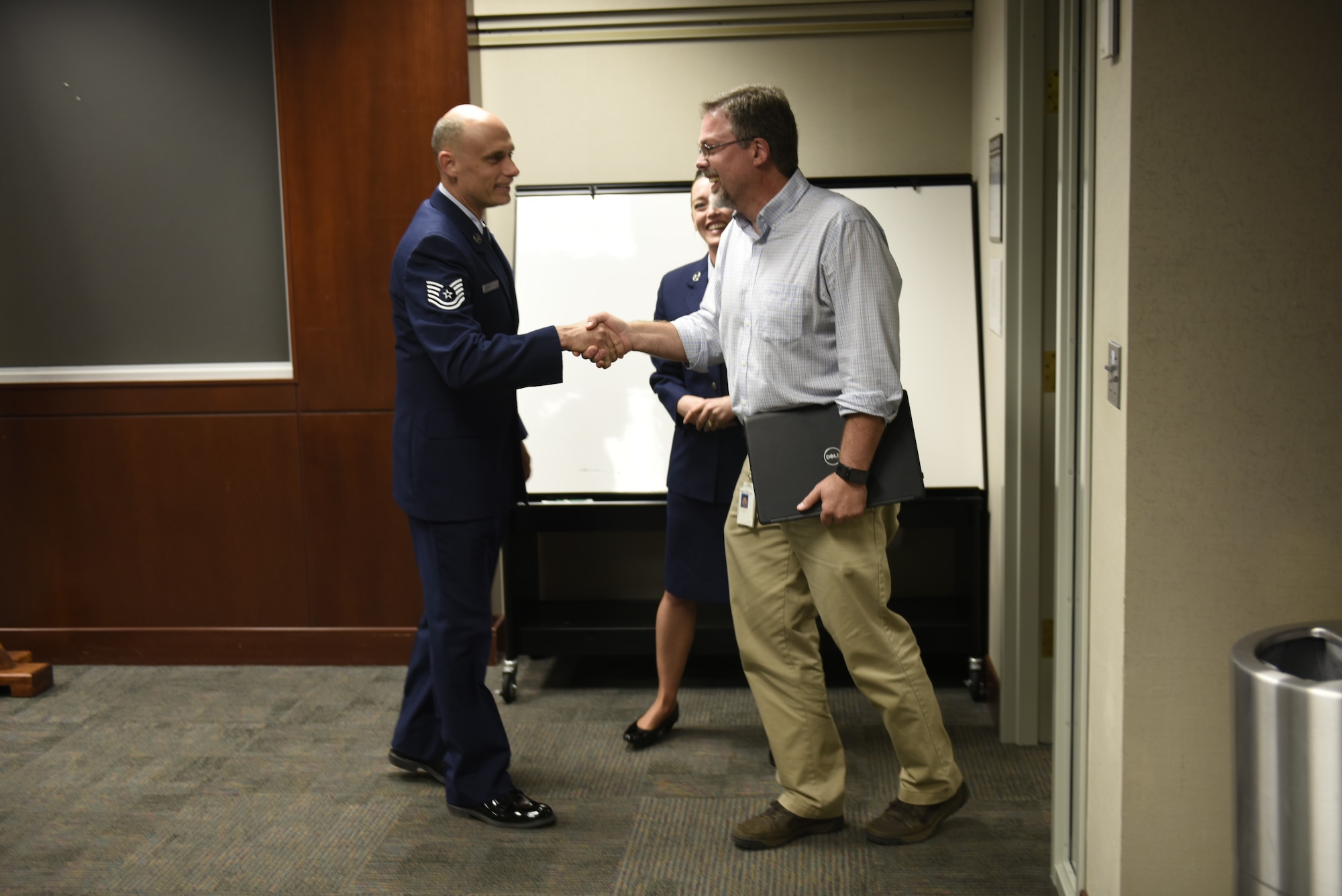 U.S. Air Force Tech. Sgt. Stacey Wakefield, a drill status guardsman with the 156th Aeromedical Evacuation Squadron, shake the hand of his civilian supervisor Mr. Chris Mendlik after organizing a surprise ceremony to present the ESGR Patriotic Employer Award at the Wells Fargo Charlotte Customer Information Center, NC, June 14, 2019. The Patriotic Employer Award is the first level that an employer can be nominated for, and reflects the efforts made to support citizen warriors through a wide-range of measures including flexible schedules, time off prior to and after deployment, caring for families, and granting leaves of absence if needed.