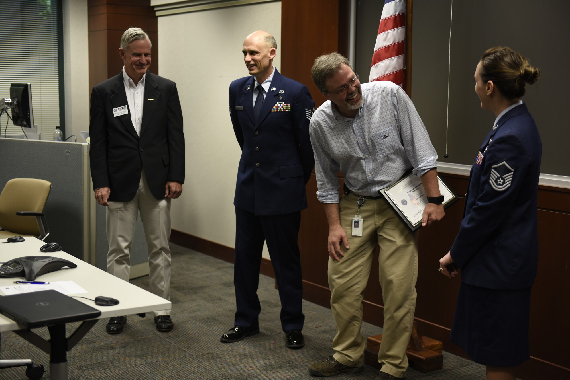 From left to right Mr. Kevin Spalding Area Chair with the North Carolina ESGR, U.S. Air Force Tech. Sgt. Stacey Wakefield of the 156th Aeromedical Evacuation Squadron, Mr. Chris Mendlik Wells Fargo Information Security Manager, and Master Sgt. Sara Evans with the 131st Bomb Wing laugh after Mr. Mendlik was surprised by a ceremony to present the ESGR Patriotic Employer Award at the Wells Fargo Charlotte Customer Information Center, NC, June 14, 2019. The Patriotic Employer Award is the first level that an employer can be nominated for, and reflects the efforts made to support citizen warriors through a wide-range of measures including flexible schedules, time off prior to and after deployment, caring for families, and granting leaves of absence if needed.