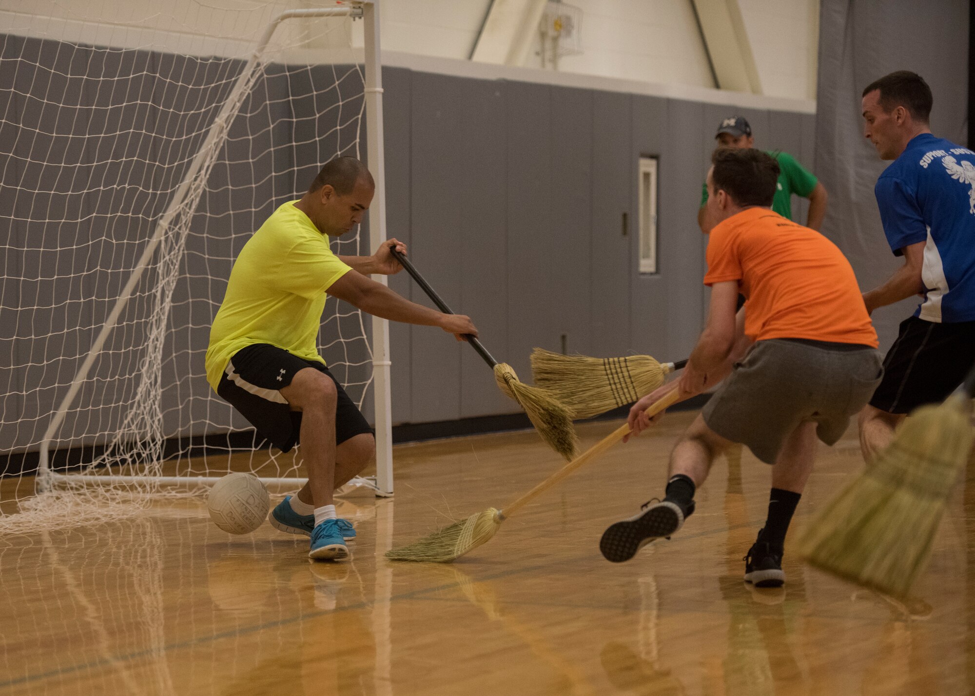An airman from the 9th Airlift Squadron scores a goal June 14, 2019, at Dover Air Force Base, Del. Broomball is a close relative to hockey, the main difference being that it is played with brooms and a volleyball and not on ice. (U.S. Air Force photo by A1C Jonathan Harding)