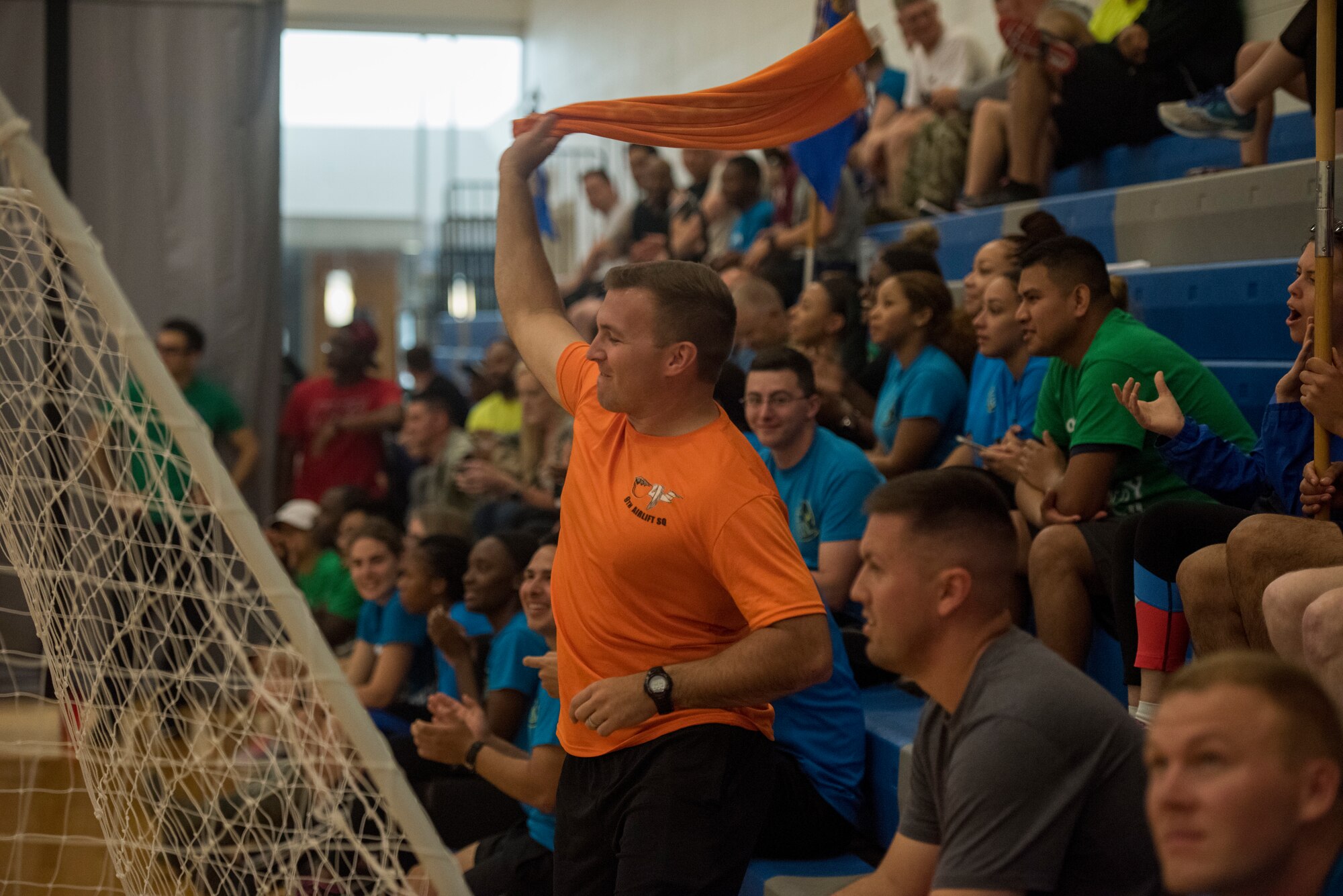 An Airman from the 9th Airlift Squadron swings a towel during the broomball event June 14, 2019 at Dover Air Force Base, Del. All military and civilian members associated with a squadron were able to participate in Sports Day. (U.S. Air Force photo by A1C Jonathan Harding)
