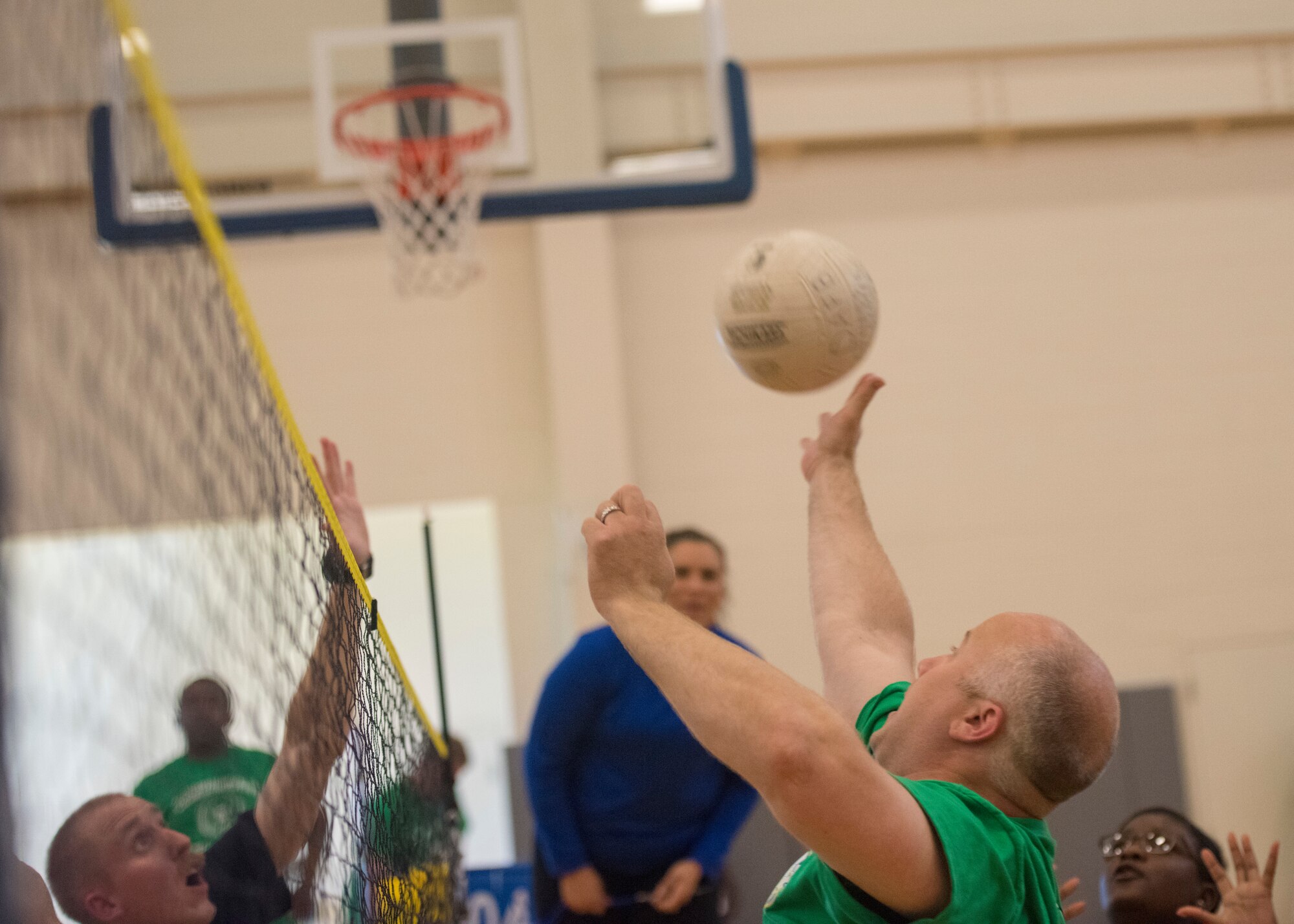 A group of Airmen prepare to hit the ball during sit-down volleyball June 14, 2019 at Dover Air Force Base, Del. The sit-down volleyball event was to recognize wounded warriors through sports and fitness and to involve a larger team for squadron participation. (U.S. Air Force photo by A1C Jonathan Harding)