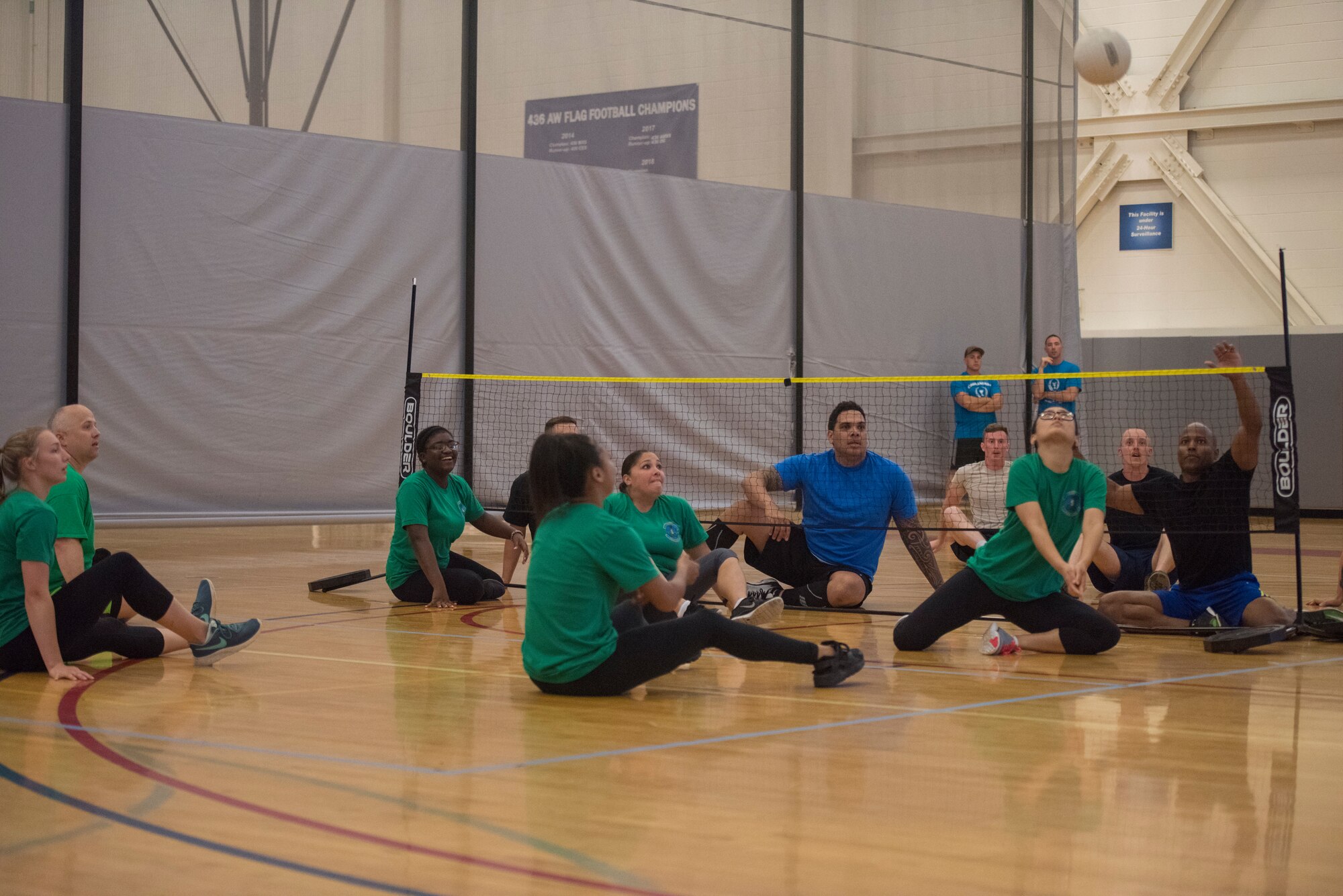 An airman from the 436th Comptroller Squadron prepares to hit the volleyball June 14, 2019 at Dover Air Force Base, Del. Within the limited space the players are not allowed to stand up but can get on their knees to hit the ball. (U.S. Air Force photo by A1C Jonathan Harding)