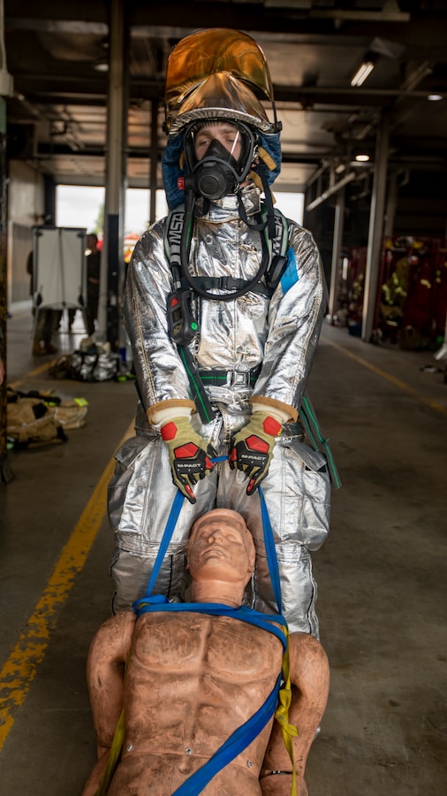 U.S. Marine Corps Lance Cpl. Anthony Zuehlke, an aircraft rescue and firefighting specialist with Marine Wing Support Squadron 471, Marine Aircraft Group 41, 4th Marine Aircraft Wing, drags a simulated casualty during a physical training test at Canadian Forces Base Cold Lake, Canada, June 14, 2019, in support of Sentinel Edge 19. Each portion of the test simulated tasks that every Reserve Marine with Aircraft Rescue and Firefighting would be expected to complete in a timely manner if an accident were to occur in an airfield. Reserve Marines with MAG-41 conducted the test to maintain job proficiency and ensure deployment readiness. (U.S. Marine Corps photo by Lance Cpl. Jose Gonzalez)
