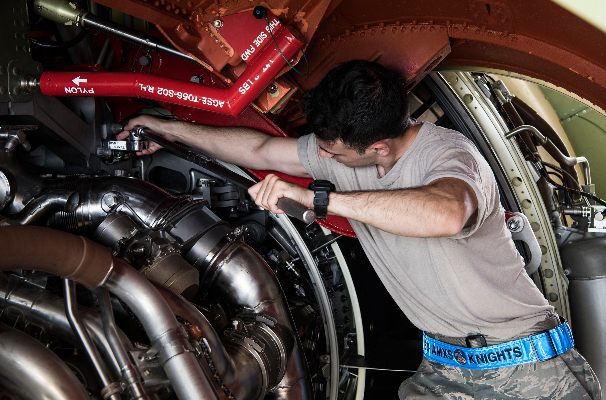 Senior Airman Chad Helminiak, 60th Aircraft Maintenance Squadron aerospace propulsion journeyman, unscrews a bolt June 6, 2019, Dover Air Force Base, Del. Helminiak and the other Airmen attending the C-5M Super Galaxy engine- changing course had to unscrew all the bolts on each side of the engine before they could begin the process of dropping the engine. (U.S. Air Force photo by Senior Airman Christopher Quail)