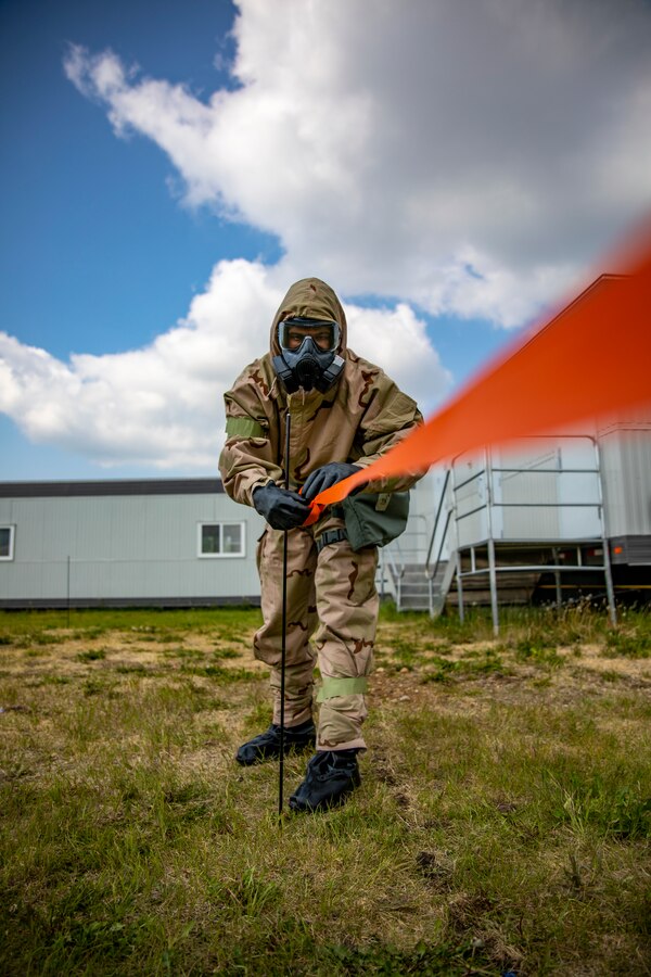 A U.S. Marine with Marine Aircraft Group 41, 4th Marine Aircraft Wing, uses barricade tape to block off a contaminated area during a chemical, biological, radiological and nuclear individual survival skills course at Canadian Forces Base Cold Lake, Canada, June 14, 2019, in support of Sentinel Edge 19. CBRN training test Marines abilities to respond in the event of chemical, biological, radiological or nuclear contamination. Training exercises such as SE19 ensure Reserve Marines are proficient and capable of successful integration with active-duty Marines, making Marine Forces Reserve critical to the Marine Corps’ Total Force. (U.S. Marine Corps photo by Sgt. Andy O. Martinez)