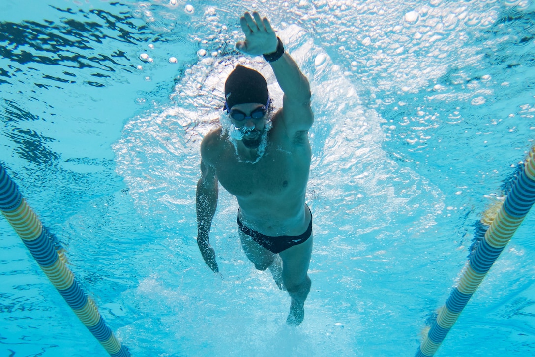 A swimmer does laps in a pool.