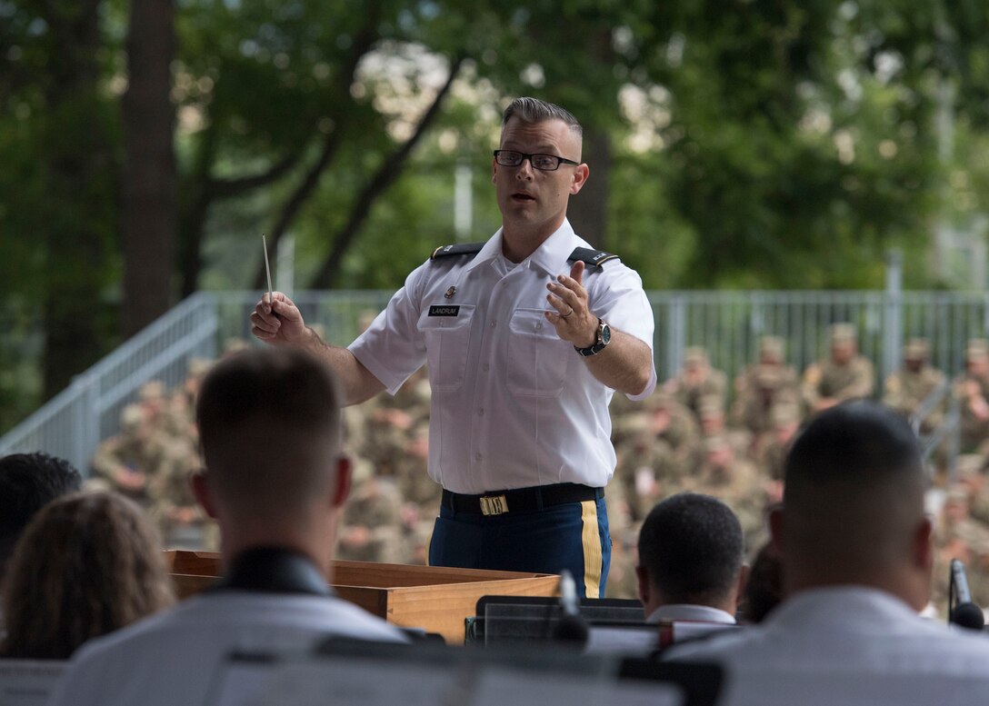 U.S. Army Chief Warrant Officer 2 James Landrum, 392nd Army Band commander, conducts band members during the “Music Under the Stars” concert series at Joint Base Langley-Eustis, Virginia, June 13, 2019.