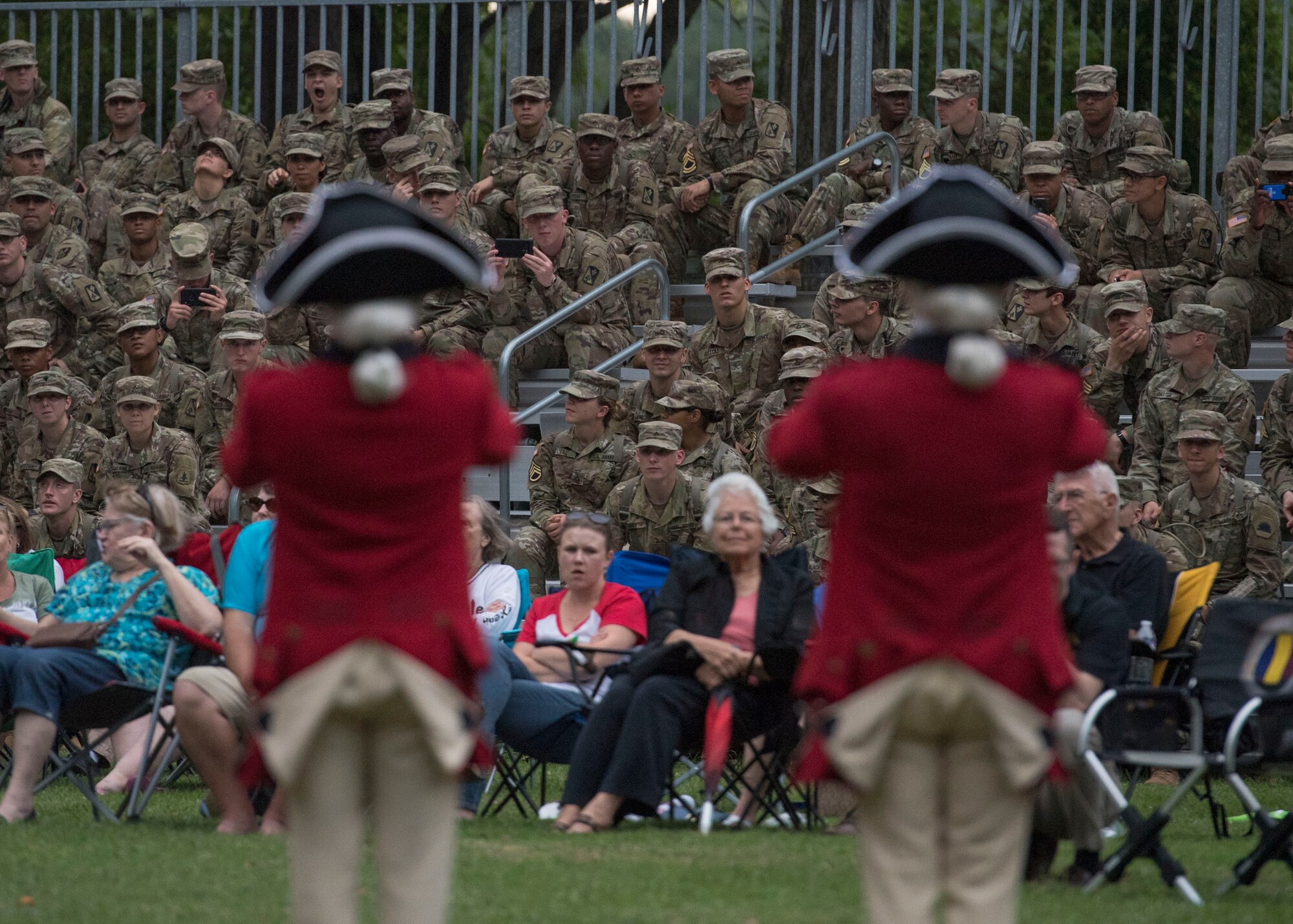 U.S. Army Advanced Individual Training Soldiers and event attendees watch a performance by the U.S. Army Old Guard Fife and Drum Corps during the “Music Under the Stars” concert series at Joint Base Langley-Eustis, Virginia, June 13, 2019.