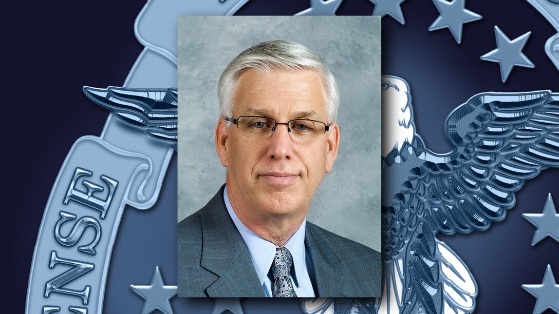 A portrait of Patrick McCormick over a background featuring the DLA emblem