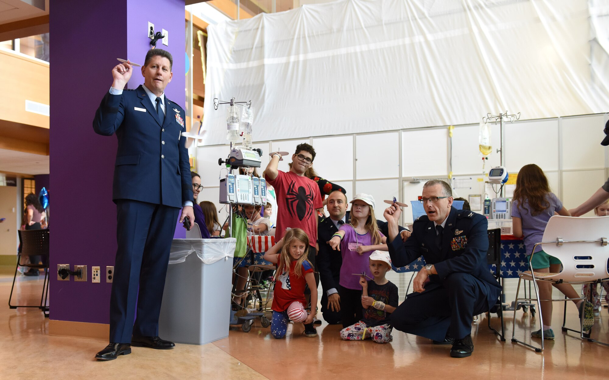 Lt. Gen. David Thompson, Air Force Space Command vice commander, prepares for a toy airplane race with Public Affairs Officer Capt. Justin Lewis, 911th Operations Group Commander Col. Gregory Buchanan, patients and their families at the Children’s Hospital of Pittsburgh, June 14, 2019.