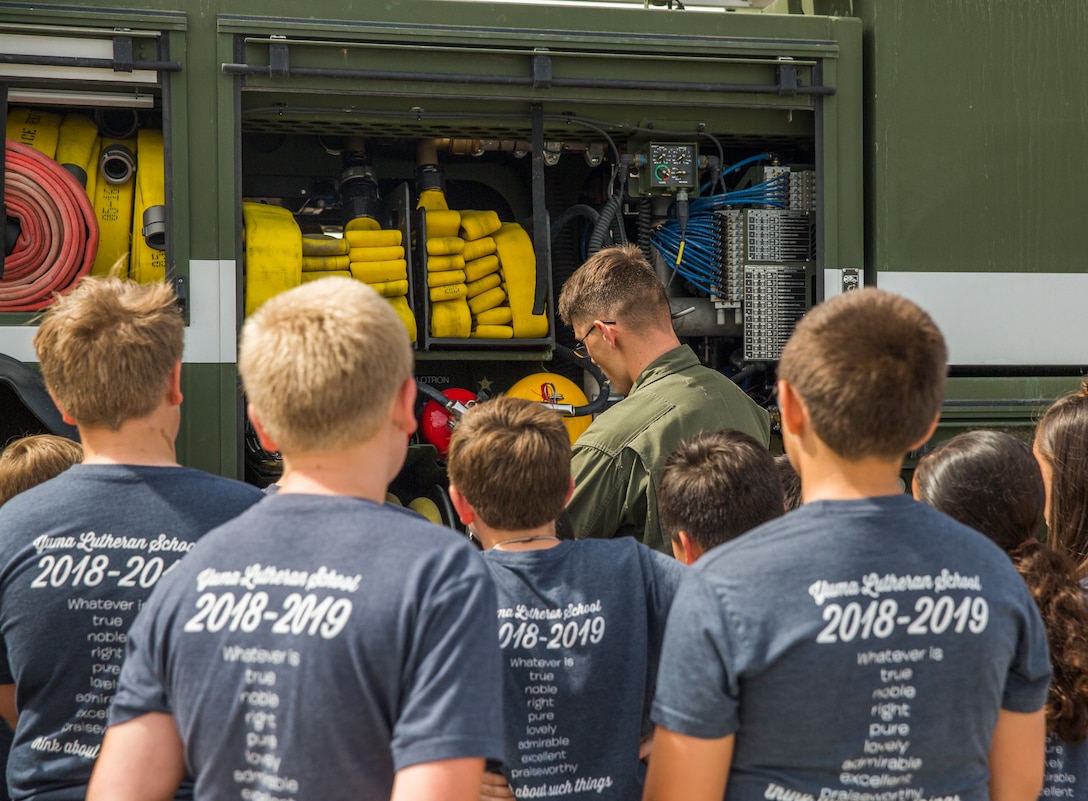Students from Yuma Lutheran School and Desert Sonora Elementary School visit Marine Corps Air Station (MCAS) Yuma, Ariz., May 9, 2019. The students observed a demonstration of a military working dog, Marine Corps Martial Arts Program (MCMAP) techniques, and the Marine Corps Obstacle Course. They were also able to see various static displays ranging from a Search and Rescue (SAR) helicopter to a AV-8B Harrier. (U.S. Marine Corps photo by Cpl. Sabrina Candiaflores)