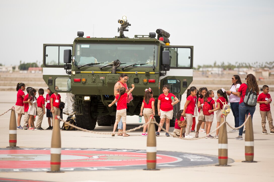 Students from Yuma Lutheran School and Desert Sonora Elementary School visit Marine Corps Air Station (MCAS) Yuma, Ariz., May 9, 2019. The students observed a demonstration of a military working dog, Marine Corps Martial Arts Program (MCMAP) techniques, and the Marine Corps Obstacle Course. They were also able to see various static displays ranging from a Search and Rescue (SAR) helicopter to a AV-8B Harrier. (U.S. Marine Corps photo by Cpl. Sabrina Candiaflores)