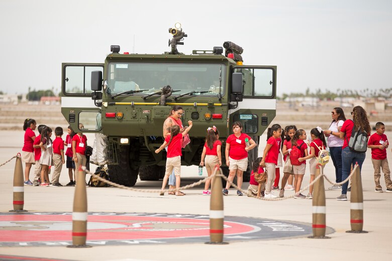 Students from Yuma Lutheran School and Desert Sonora Elementary School visit Marine Corps Air Station (MCAS) Yuma, Ariz., May 9, 2019. The students observed a demonstration of a military working dog, Marine Corps Martial Arts Program (MCMAP) techniques, and the Marine Corps Obstacle Course. They were also able to see various static displays ranging from a Search and Rescue (SAR) helicopter to a AV-8B Harrier. (U.S. Marine Corps photo by Cpl. Sabrina Candiaflores)