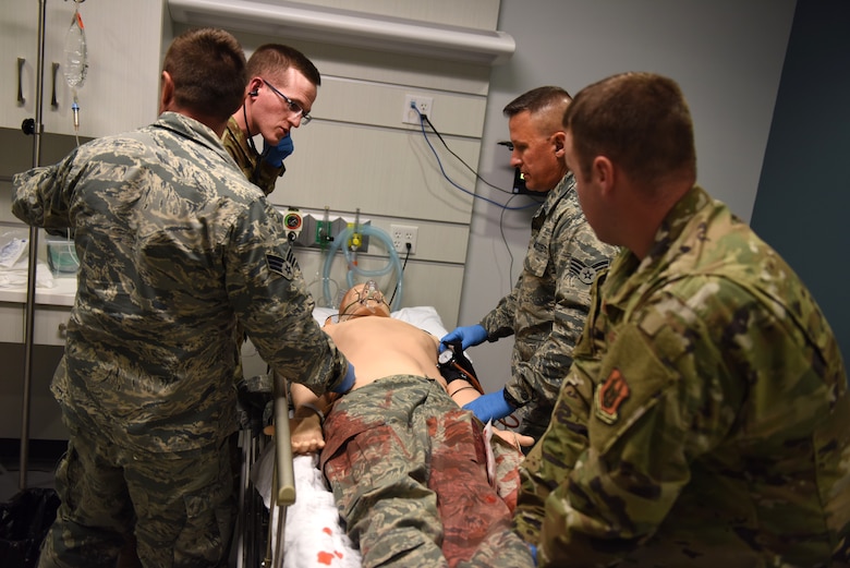 Capt. Brenden Stokes, Tech. Sgt. Josh Means, and Senior Airmen Stephen Barley and Jeffrey Smidga of the 911th Aeromedical Staging Squadron practice medical procedures on a high-tech mannequin at Robert Morris University in Coraopolis, Pennsylvania, June 13, 2019.
