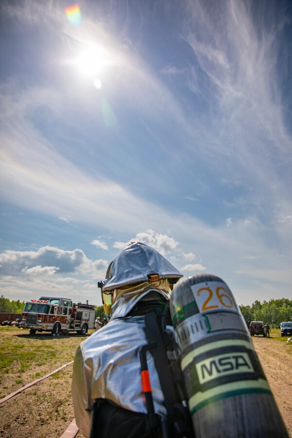 A U.S. Marine aircraft rescue and firefighting specialist with Marine Wing Support Squadron 471, Marine Aircraft Group 41, 4th Marine Aircraft Wing, pulls a fire hose during combined firefighting training at Canadian Forces Base Cold Lake, Canada, June 16, 2019, in support of Sentinel Edge 19. The Marine Reserve plays a critical component to the Marine Corps’ Total Force, and training such as SE19 helps ensure Reserve units combat effectiveness and proficiency for world-wide deployment. (U.S. Marine Corps photo by Sgt. Andy O. Martinez)