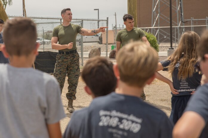 Students from Yuma Lutheran School and Desert Sonora Elementary School visit Marine Corps Air Station (MCAS) Yuma, Ariz., May 9, 2019. The students observed a demonstration of a military working dog, Marine Corps Martial Arts Program (MCMAP) techniques, and the Marine Corps Obstacle Course. They were also able to see various static displays ranging from a Search and Rescue (SAR) helicopter to a AV-8B Harrier. (U.S. Marine Corps photo by Cpl. Sabrina Candiaflores)