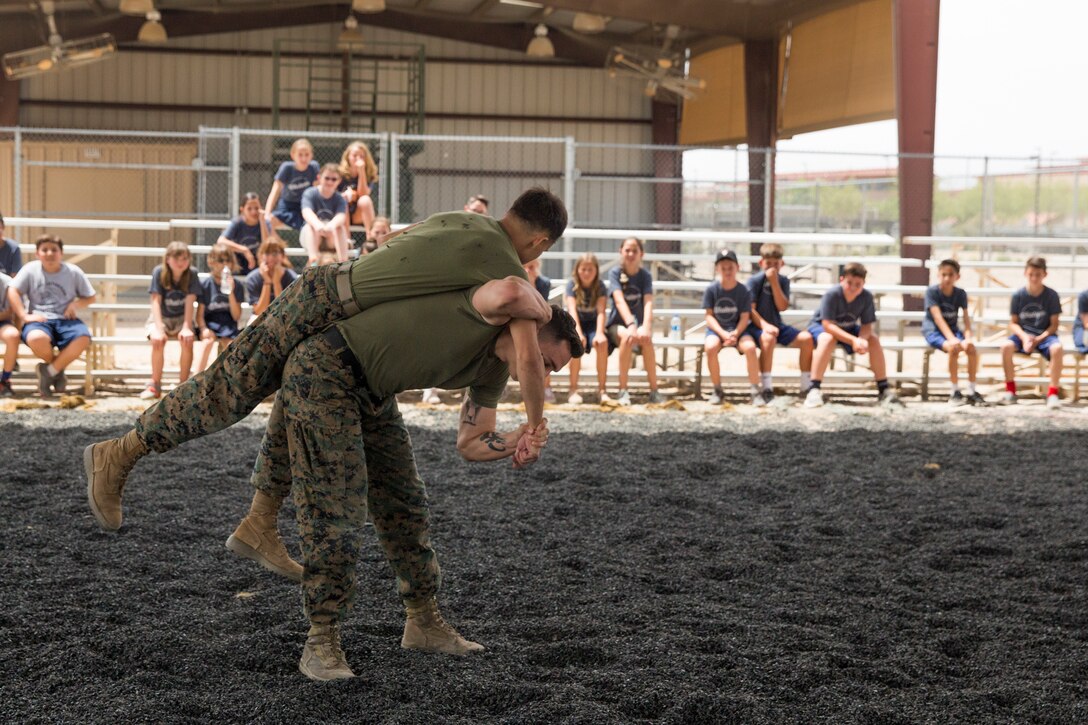 Students from Yuma Lutheran School and Desert Sonora Elementary School visit Marine Corps Air Station (MCAS) Yuma, Ariz., May 9, 2019. The students observed a demonstration of a military working dog, Marine Corps Martial Arts Program (MCMAP) techniques, and the Marine Corps Obstacle Course. They were also able to see various static displays ranging from a Search and Rescue (SAR) helicopter to a AV-8B Harrier. (U.S. Marine Corps photo by Cpl. Sabrina Candiaflores)