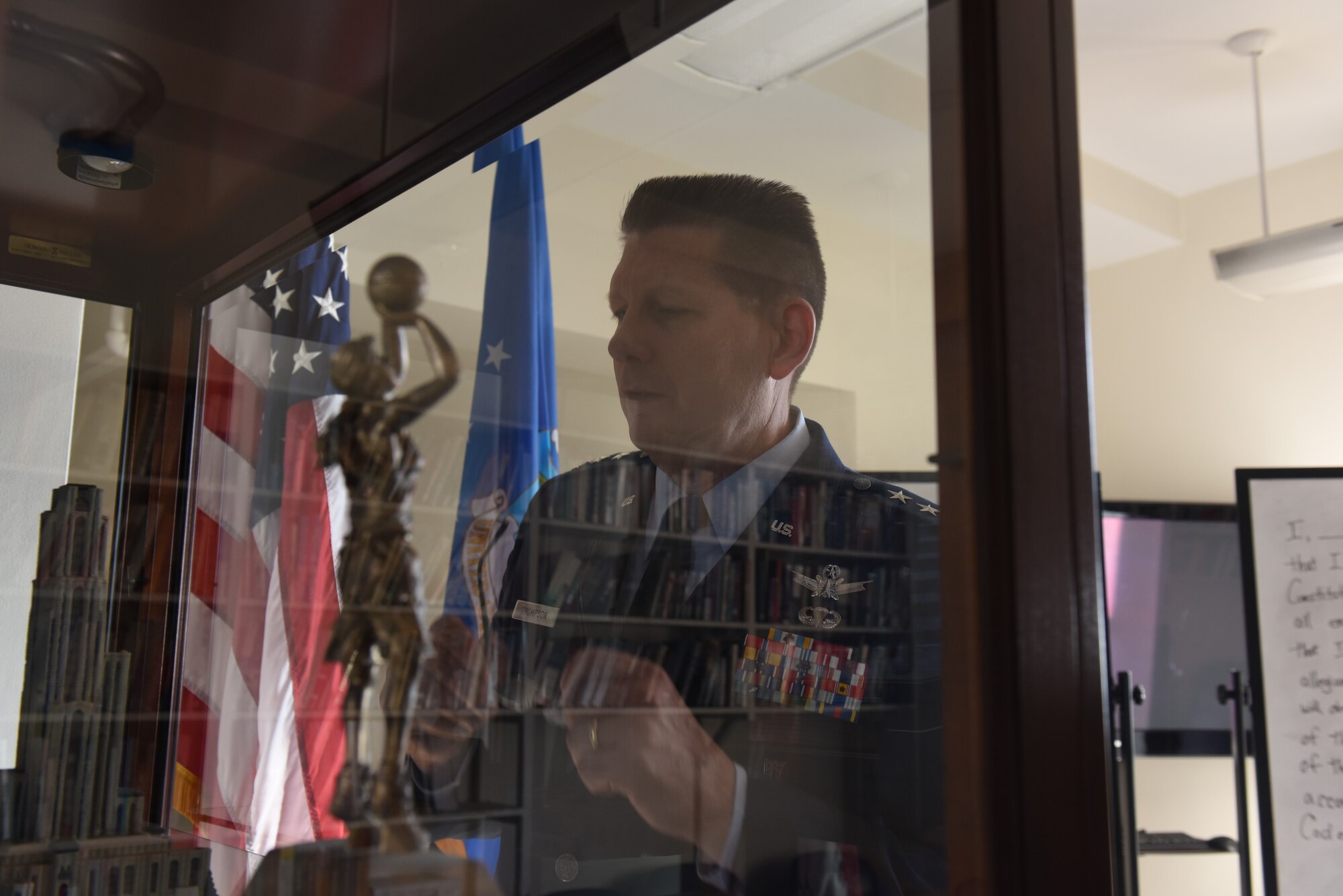 Lt. Gen. David Thompson, Air Force Space Command vice commander, looks at trophies given to Air Force ROTC Detachment 730 in Pittsburgh, June 14, 2019.