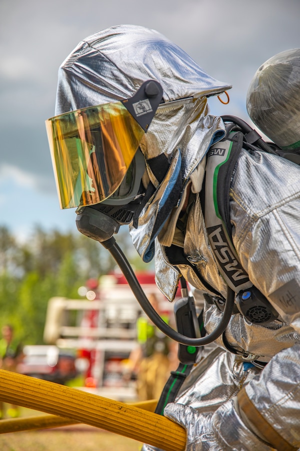 A U.S. Marine aircraft rescue and firefighting specialist with Marine Wing Support Squadron 471, Marine Aircraft Group 41, 4th Marine Aircraft Wing, holds a fire hose during combined firefighting training at Canadian Forces Base Cold Lake, Canada, June 16, 2019, in support of Sentinel Edge 19. The Marine Reserve plays a critical component to the Marine Corps’ Total Force, and training such as SE19 helps ensure Reserve units combat effectiveness and proficiency for world-wide deployment. (U.S. Marine Corps photo by Sgt. Andy O. Martinez)